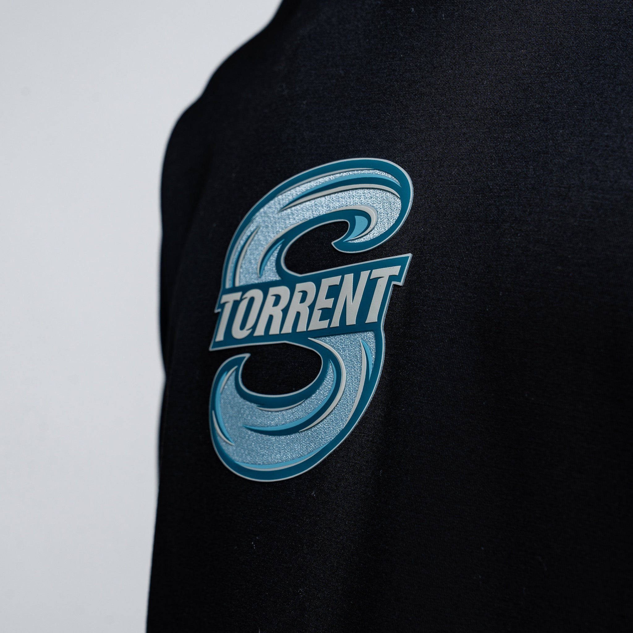 Black shirt with blue 'Torrent' logo on a light gray background