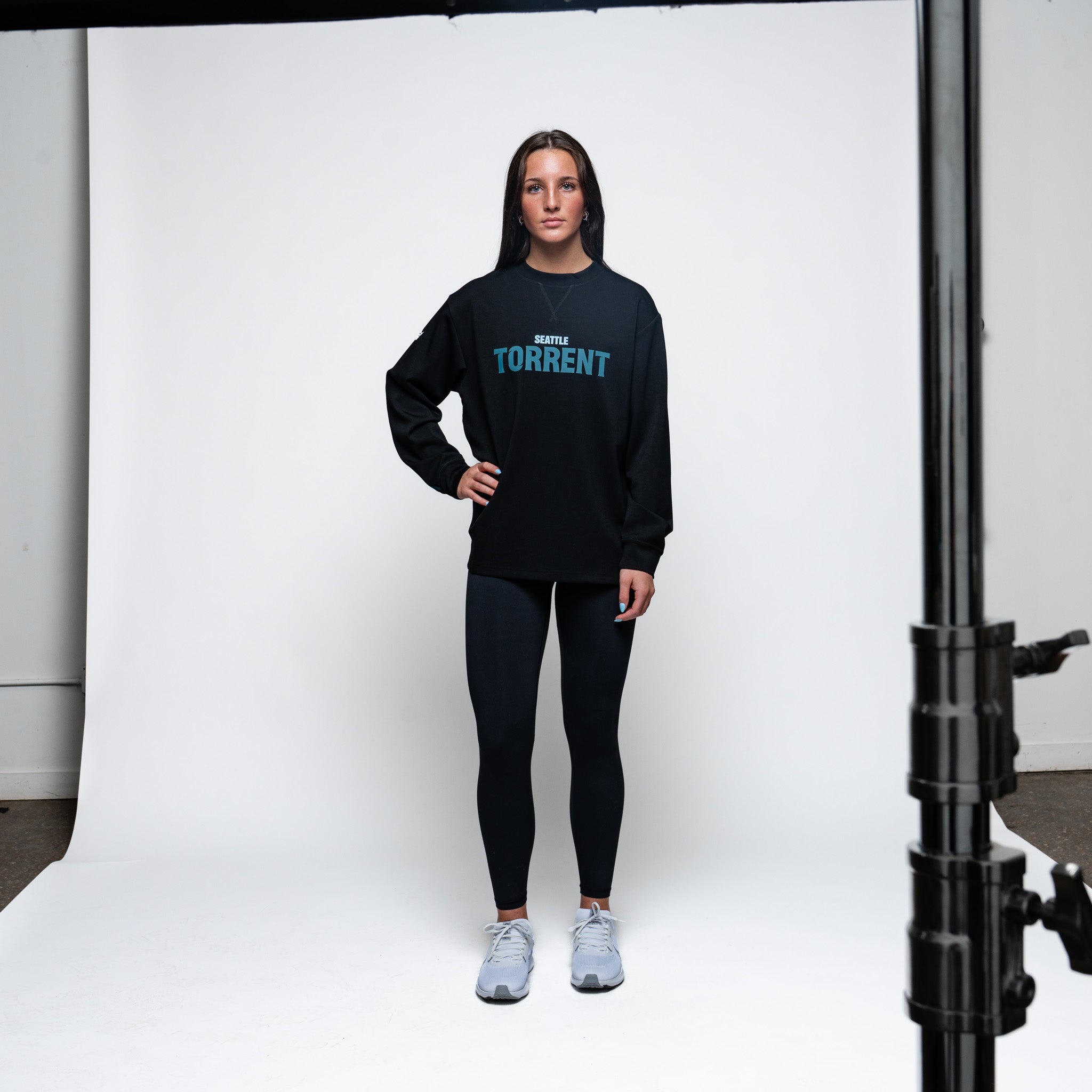 Person wearing a black hoodie with 'TORRENT' text on a white background