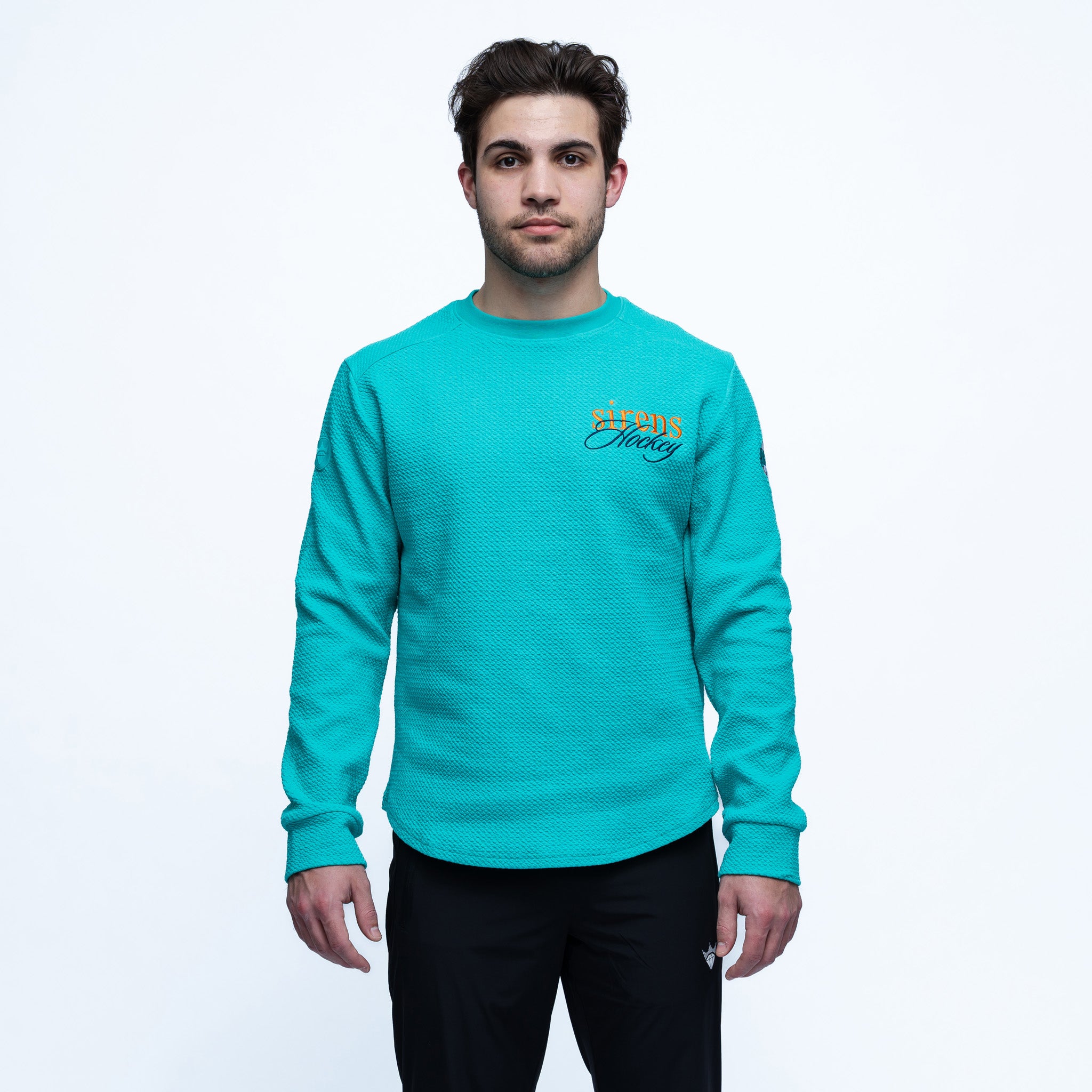 Person wearing a teal sweatshirt with text on a white background
