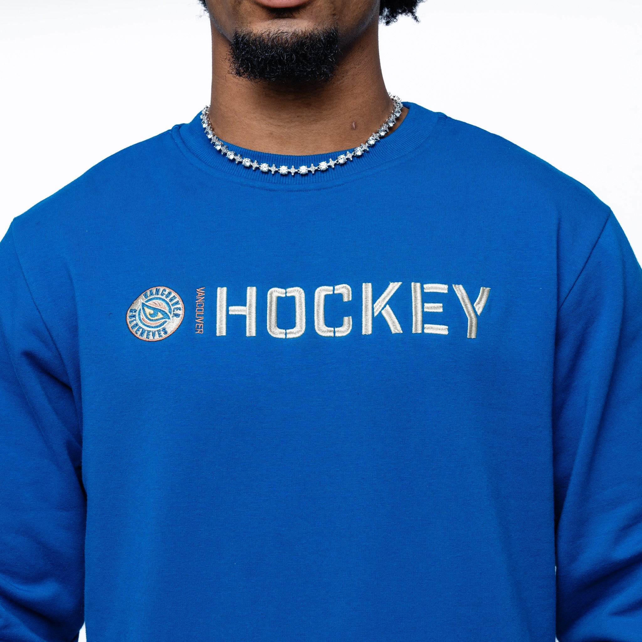 Close up of the embroidery on the blue Adult Vancouver Goldeneyes Royalty Everyday Cloud Crew