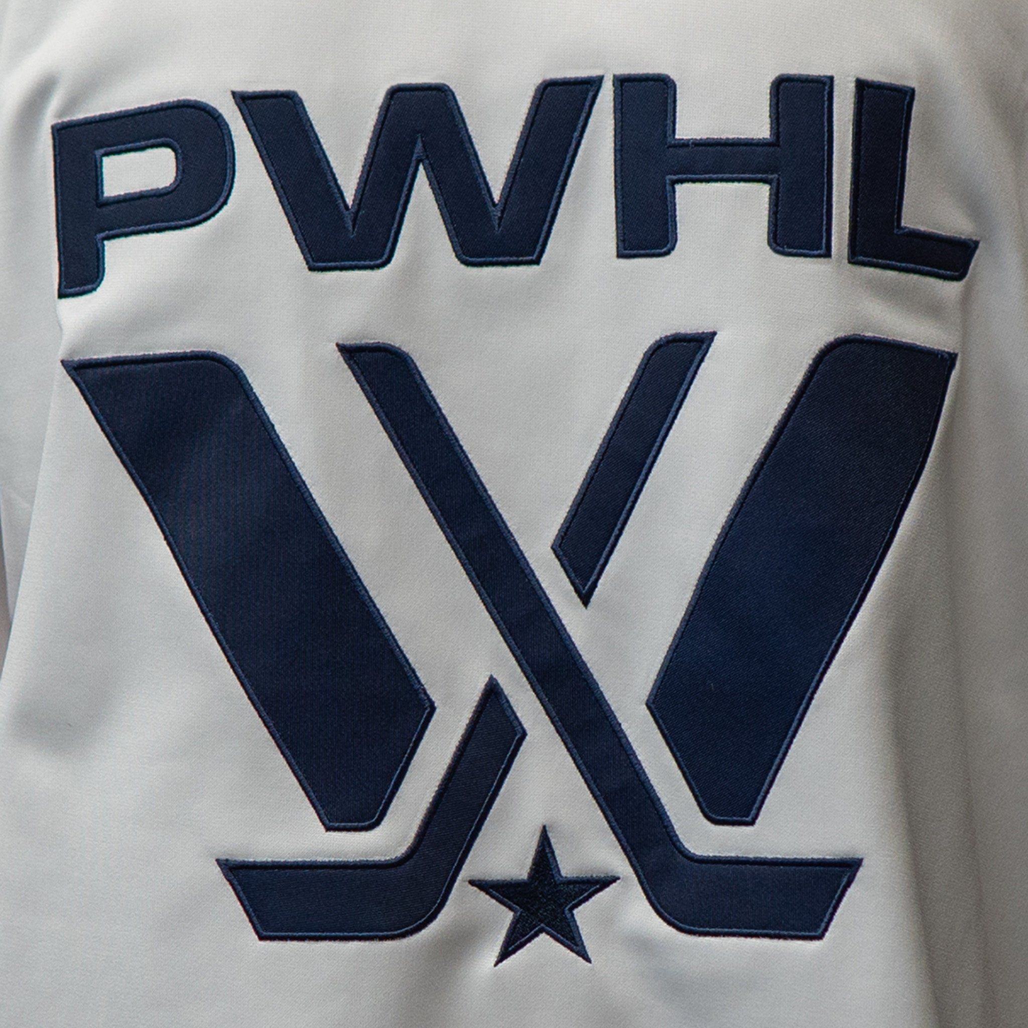 Close up of the front PWHL name and logo with navy stitching and fill and a navy embroidered star